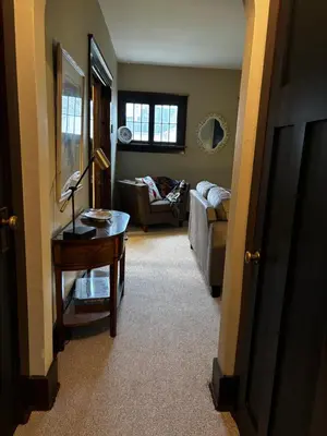 a living room with a table and a couch at The Inn on Holgate Avenue in Defiance