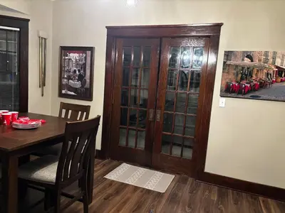 a dining room with a table and a wooden cabinet at The Inn on Holgate Avenue in Defiance