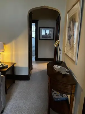 a hallway with a door leading to a room at The Inn on Holgate Avenue in Defiance