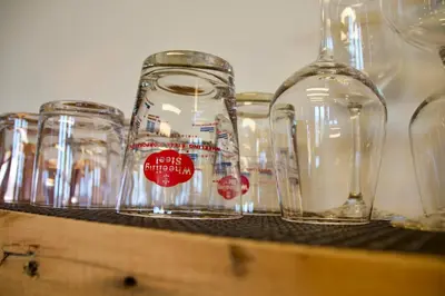 a row of empty wine glasses sitting on a shelf at The Historic Berry Loft at Waterfront Hall in Wheeling