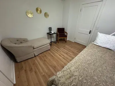 a bedroom with a bed and a couch and a chair at Sunset Cornfield Oasis in Whiteford Center