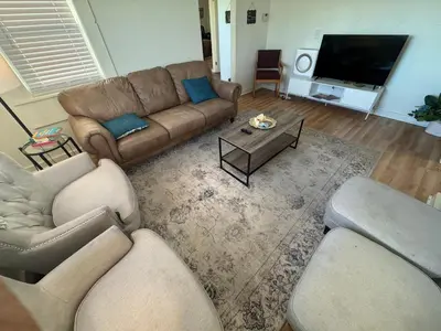 a living room with a couch and a tv at Sunset Cornfield Oasis in Whiteford Center