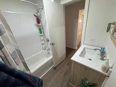 a bathroom with a sink and a shower and a tub at Sunset Cornfield Oasis in Whiteford Center