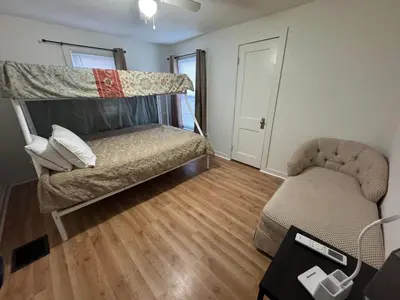 a living room with a bunk bed and a couch at Sunset Cornfield Oasis in Whiteford Center