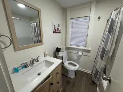 a bathroom with a sink and a toilet and a mirror at Sunset Cornfield Oasis in Whiteford Center