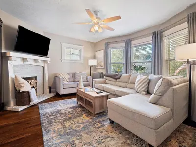 a living room with a couch and a fireplace at Stylish Lakeside Living - walk to the beach in Cleveland