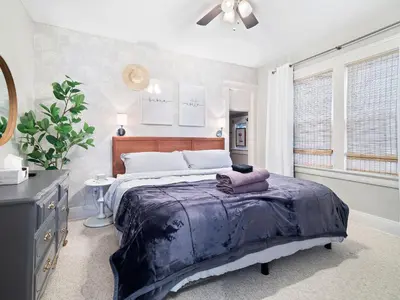 a bedroom with a large bed and a window at Stylish Lakeside Living - walk to the beach in Cleveland
