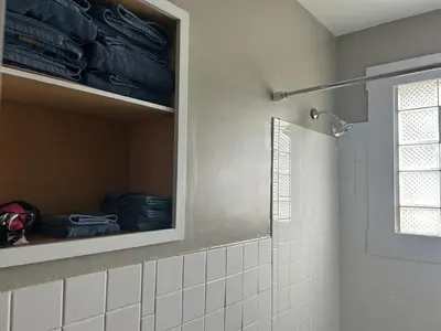 a bathroom with a shower stall and a white tiled shower at Minutes from Downtown Shopping and Dining Close to Cedar Point in Vermilion