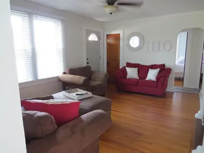 a living room with two couches and a red couch at Minutes from Downtown Shopping and Dining Close to Cedar Point in Vermilion