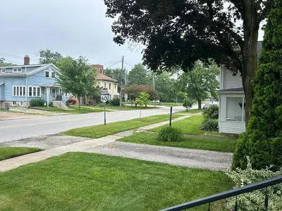 an empty street in a residential neighborhood with houses at Minutes from Downtown Shopping and Dining Close to Cedar Point in Vermilion