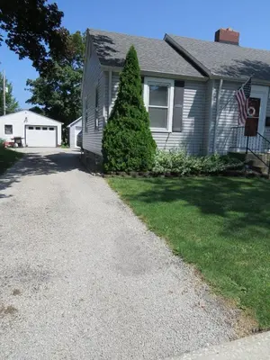 a house with an american flag in the driveway at Minutes from Downtown Shopping and Dining Close to Cedar Point in Vermilion
