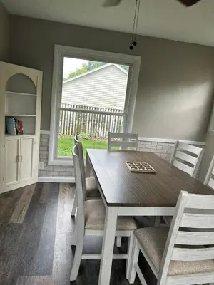 a dining room with a table and chairs and a window at Charming House, just a short walk to downtown in Vermilion