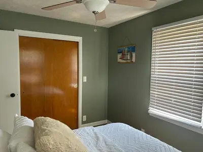 a bedroom with a bed and a ceiling fan at Charming House, just a short walk to downtown in Vermilion