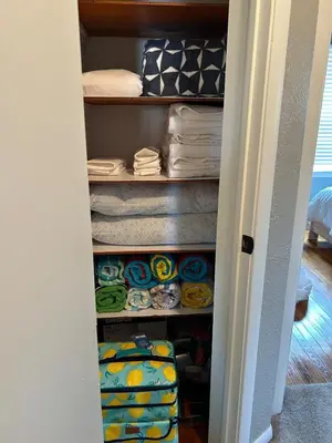 a closet filled with towels and towels at Charming House, just a short walk to downtown in Vermilion