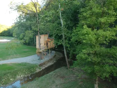 a tree house in the middle of a forest at The Royal Roost Treehouse