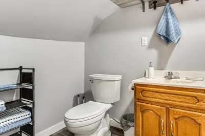 a bathroom with a toilet and a sink at Pets Welcome! Quiet Economy Home with Spacious Yard in Economy