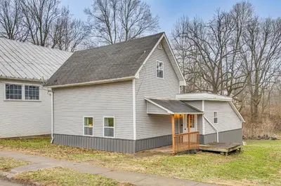a white house with a porch and a house at Pets Welcome! Quiet Economy Home with Spacious Yard in Economy