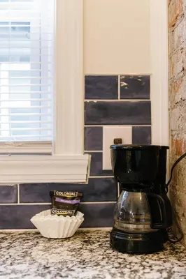 a coffee maker sitting on a counter in a kitchen at Big Blue - Stylish Studio in Downtown Lexington in Lexington