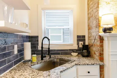 a kitchen with a sink and a window at Big Blue - Stylish Studio in Downtown Lexington in Lexington