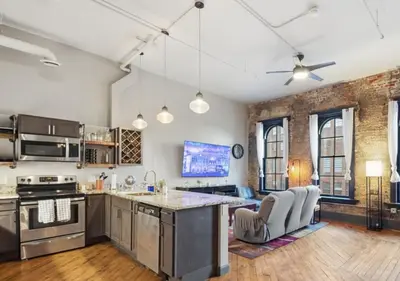 an open kitchen with a large island in a room at Speakeasy Attached, Walkable to Cavs, Flats, Casino in Cleveland