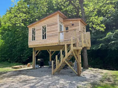a tree house sitting on top of a tree at The Owl's Perch Treehouse
