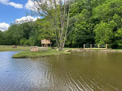 a small island in the middle of a body of water at The Owl's Perch Treehouse