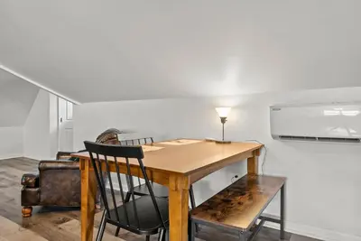 a dining room table with a lamp and a chair at Bourbon Trail - Loft in Downtown Lexington in Lexington
