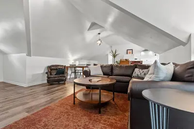 a living room with a couch and a table at Bourbon Trail - Loft in Downtown Lexington in Lexington