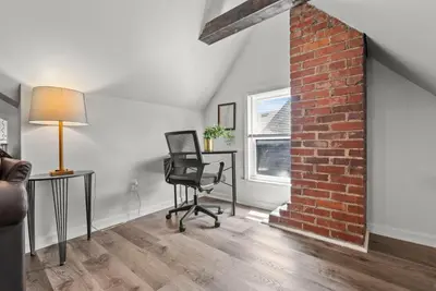 an office with a chair and a brick wall at Bourbon Trail - Loft in Downtown Lexington in Lexington