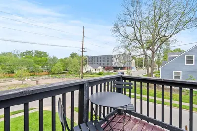 a patio with a table and chairs on a balcony at Bourbon Trail - Loft in Downtown Lexington in Lexington