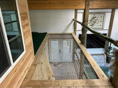 an inside view of a bird cage in a house at The Conservatory at Owl Hollow in Woodsfield