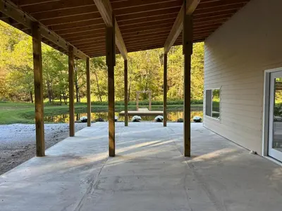 an empty patio with a wooden roof on a building at The Conservatory at Owl Hollow in Woodsfield