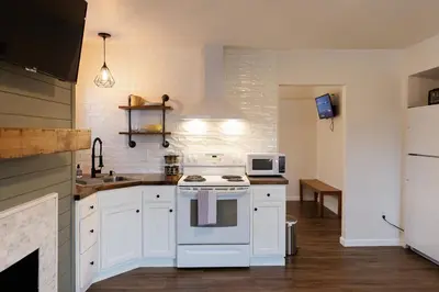 a kitchen with a white stove and a microwave at Green Oasis - Studio in Downtown Lexington in Lexington