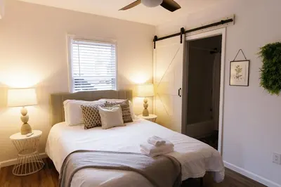 a bedroom with a bed with two towels on it at Green Oasis - Studio in Downtown Lexington in Lexington