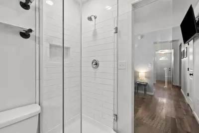 a bathroom with a shower with a glass door at Mint Julep - Studio in Downtown Lexington in Lexington