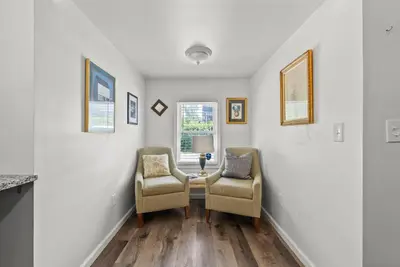 a hallway with two chairs and a table with a lamp at Mint Julep - Studio in Downtown Lexington in Lexington
