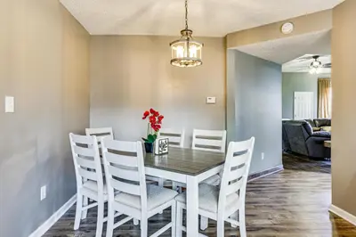 a dining room with a table and white chairs at 6 Mi to Dtwn Cincinnati Dog-Friendly Apt with Yard in Cincinnati