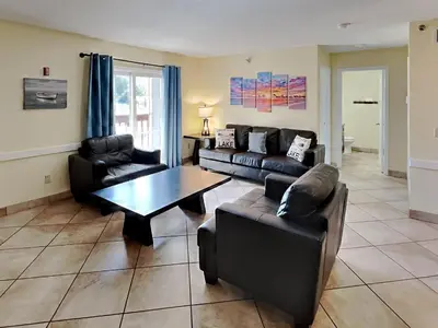 a living room with a couch and a table at Put-in-Bay Poolview Condo #6 in Put-in-Bay