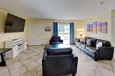 a living room with a couch and a tv at Put-in-Bay Poolview Condo #6 in Put-in-Bay