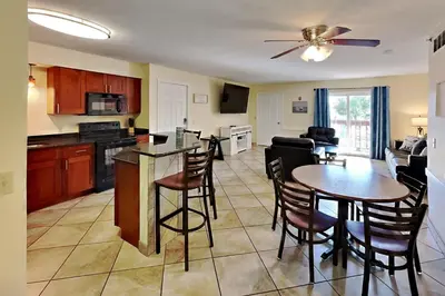 a kitchen and living room with a table and chairs at Put-in-Bay Poolview Condo #6 in Put-in-Bay