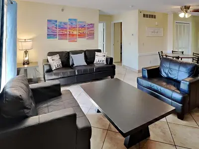 a living room with couches and a coffee table at Put-in-Bay Poolview Condo #6 in Put-in-Bay