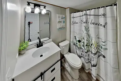 a bathroom with a sink and a toilet and a shower curtain at Put-in-Bay Island Club #65 in Put-in-Bay