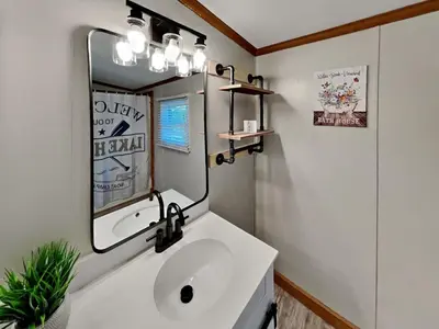 a bathroom with a sink and a mirror at Put-in-Bay Island Club #65 in Put-in-Bay