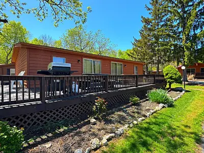 a log cabin with a fence and a yard at Put-in-Bay Island Club #9 in Put-in-Bay