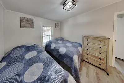 a bedroom with two beds and a dresser in it at Put-in-Bay Island Club #21 in Put-in-Bay