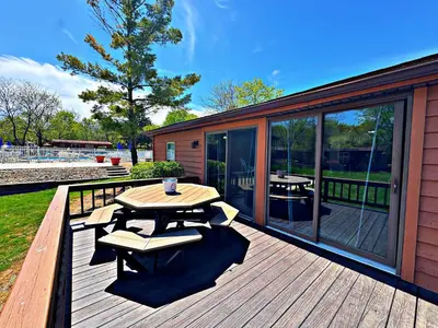 a wooden deck with a picnic table and chairs on it at Put-in-Bay Island Club #21 in Put-in-Bay