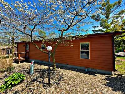 a small house with a tree in front of it at Put-in-Bay Island Club #21 in Put-in-Bay