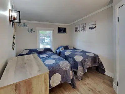 a bedroom with two beds and a table at Put-in-Bay Island Club #22 in Put-in-Bay