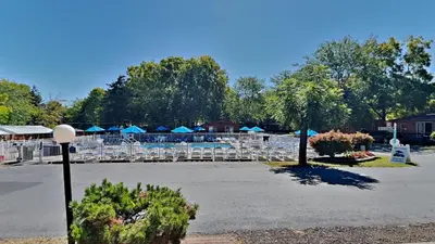 a parking lot with chairs and tables and umbrellas at Put-in-Bay Island Club #22 in Put-in-Bay