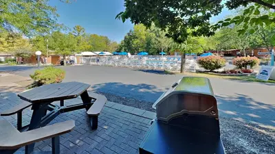 a grill sitting next to a picnic table and a bench at Put-in-Bay Island Club #22 in Put-in-Bay